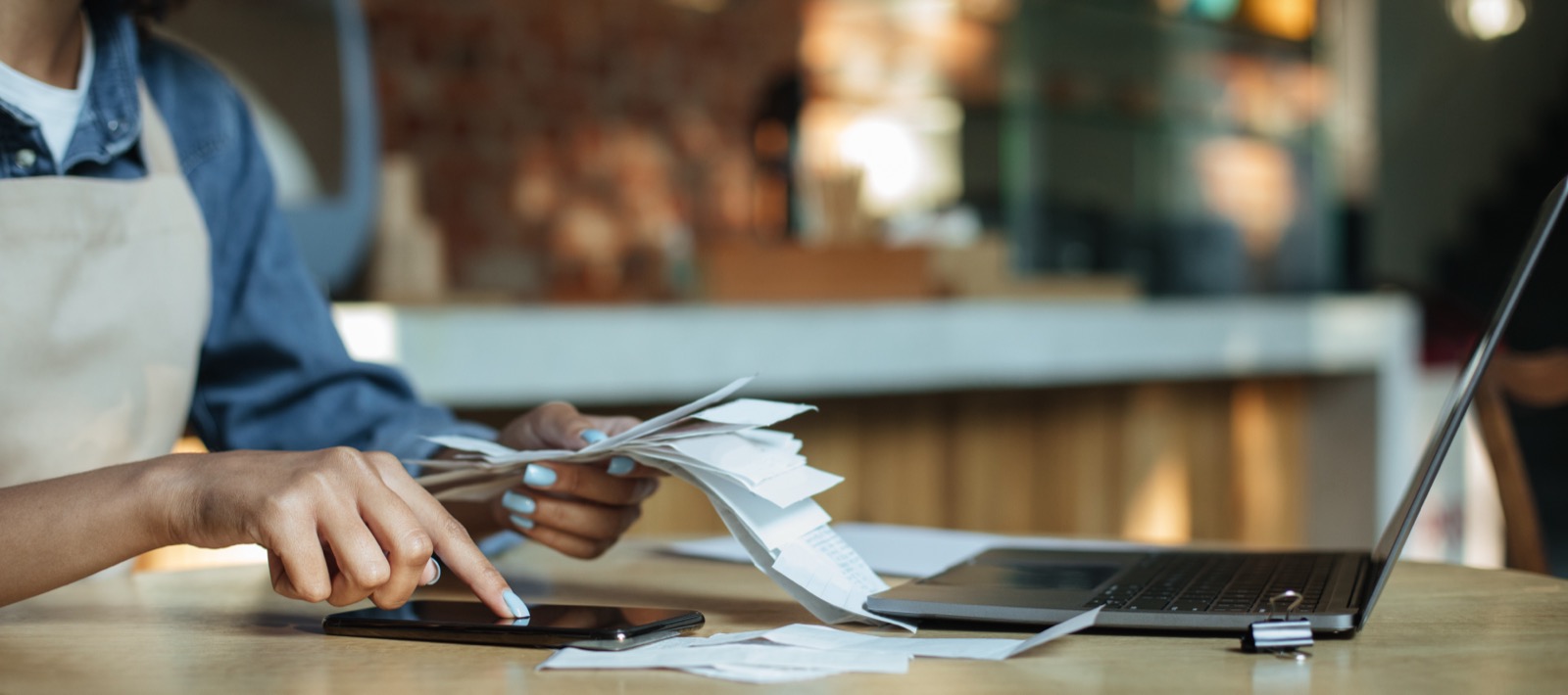 Barista taking a break to add-up invoices