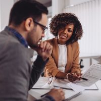 Man and woman sitting down to review finances